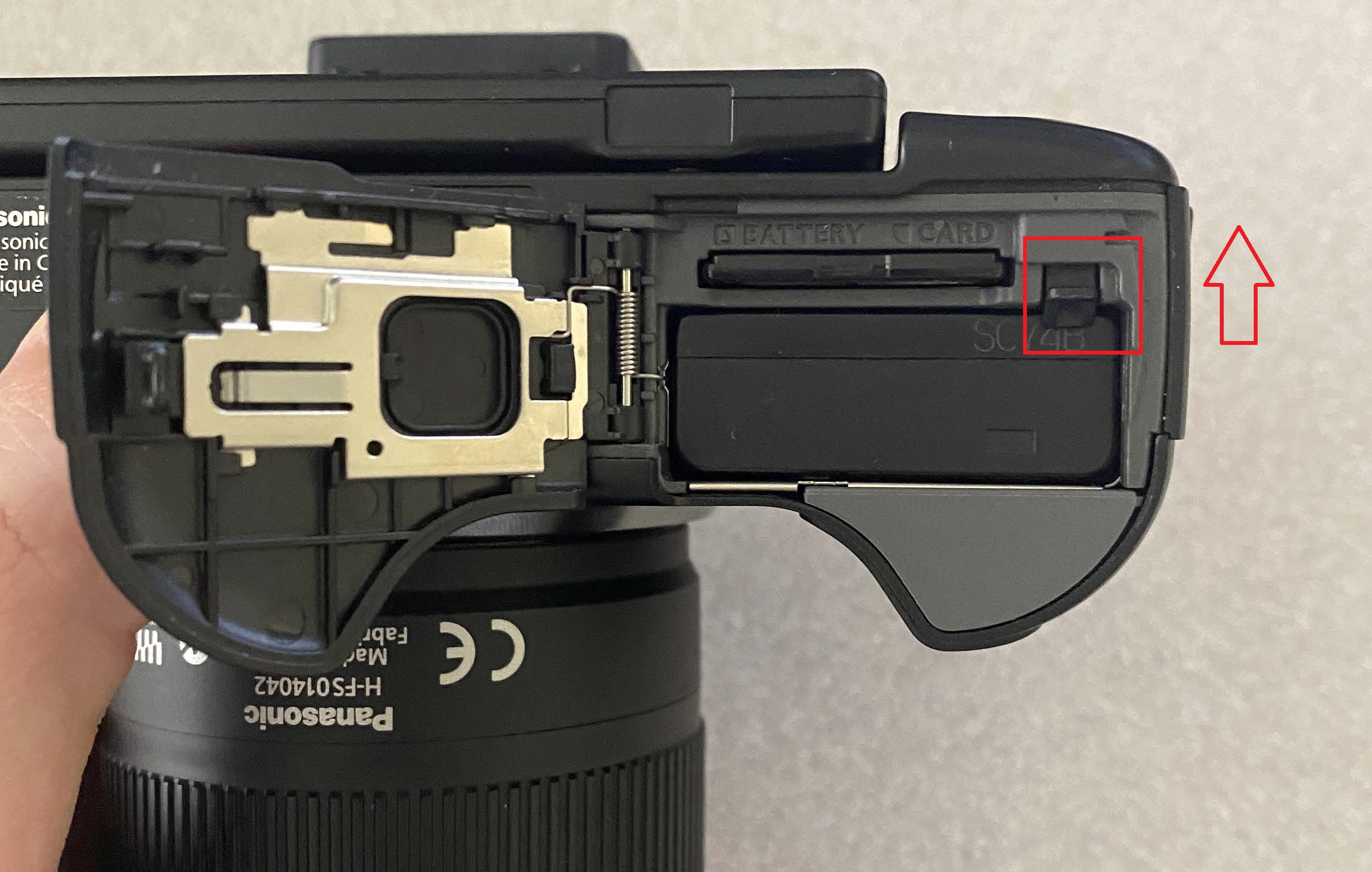 Open battery compartment in camera